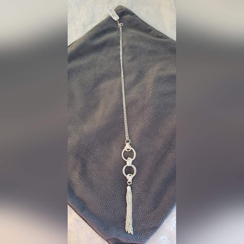 New, never worn, long, brilliant silver double ring tassel necklace.
